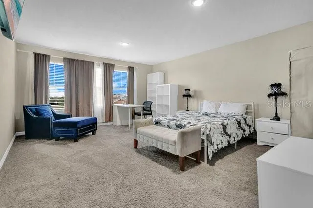 a spacious bedroom with a bed and a couch