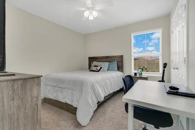 a bedroom with a bed and window