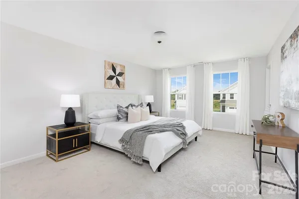 a bedroom with a bed and a wall painting