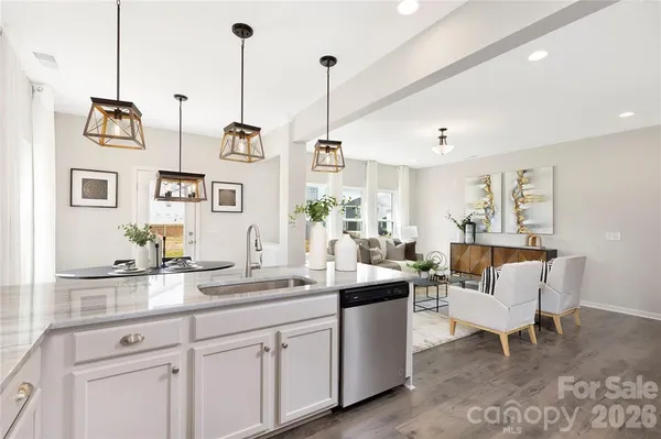 a kitchen with a table chairs refrigerator and microwave