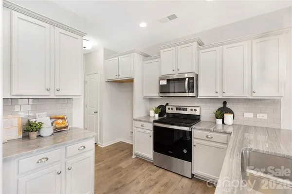 a dining room with furniture a rug and wooden floor