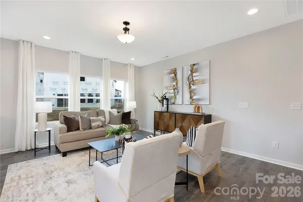 a living room with furniture white walls and white appliances