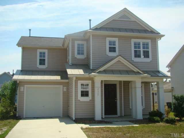 2627 Quarry Springs Road Raleigh, NC 27610 - Photo 1 of 9 a front view of a house with a yard