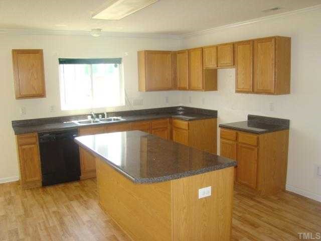 2627 Quarry Springs Road Raleigh, NC 27610 - Photo 5 of 9 a kitchen with stainless steel appliances granite countertop a sink a stove and a refrigerator