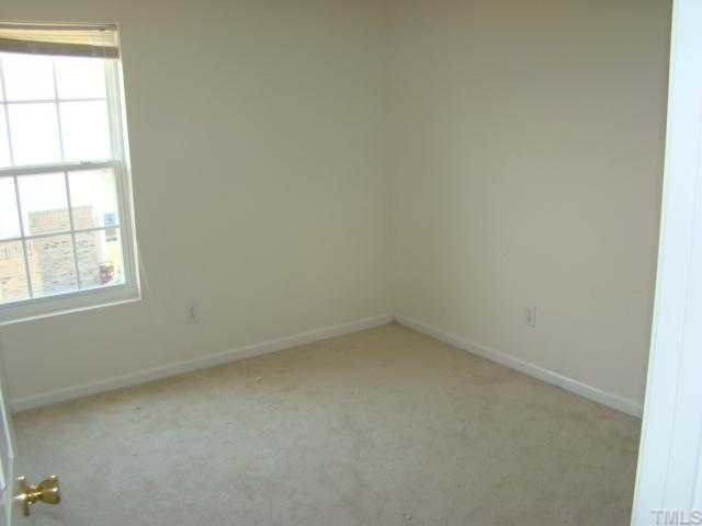 2627 Quarry Springs Road Raleigh, NC 27610 - Photo 8 of 9 an empty room with a window