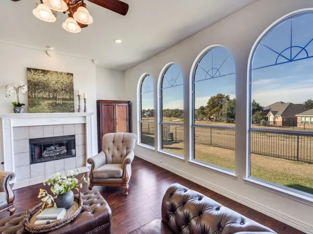 a living room with furniture and a floor to ceiling window