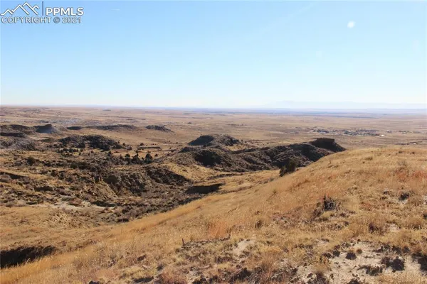 a view of a large mountain with mountains in the background