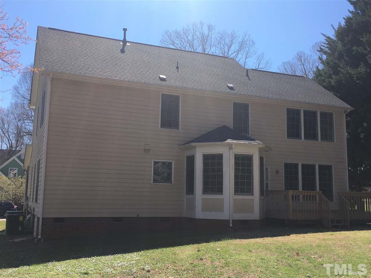 7912 Broad Street Raleigh, NC 27613 - Photo 22 of 24 a front view of a house with a yard