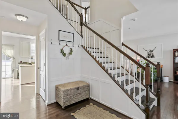 a view of staircase with wooden floor and a rug