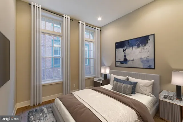 a bedroom with a bed and a painting on the wall