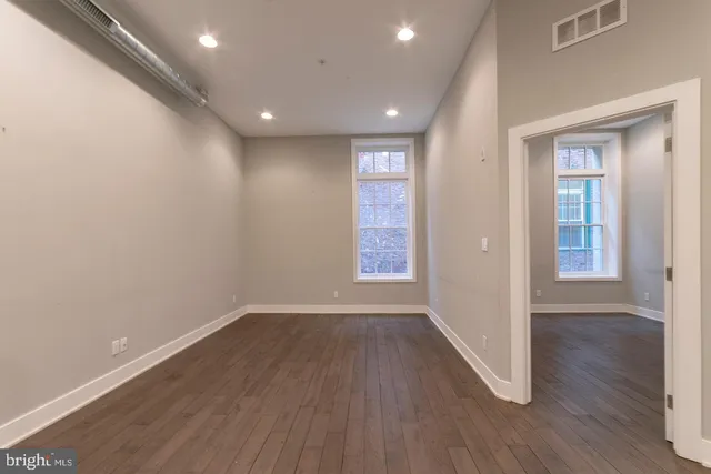 a view of hallway with wooden floor