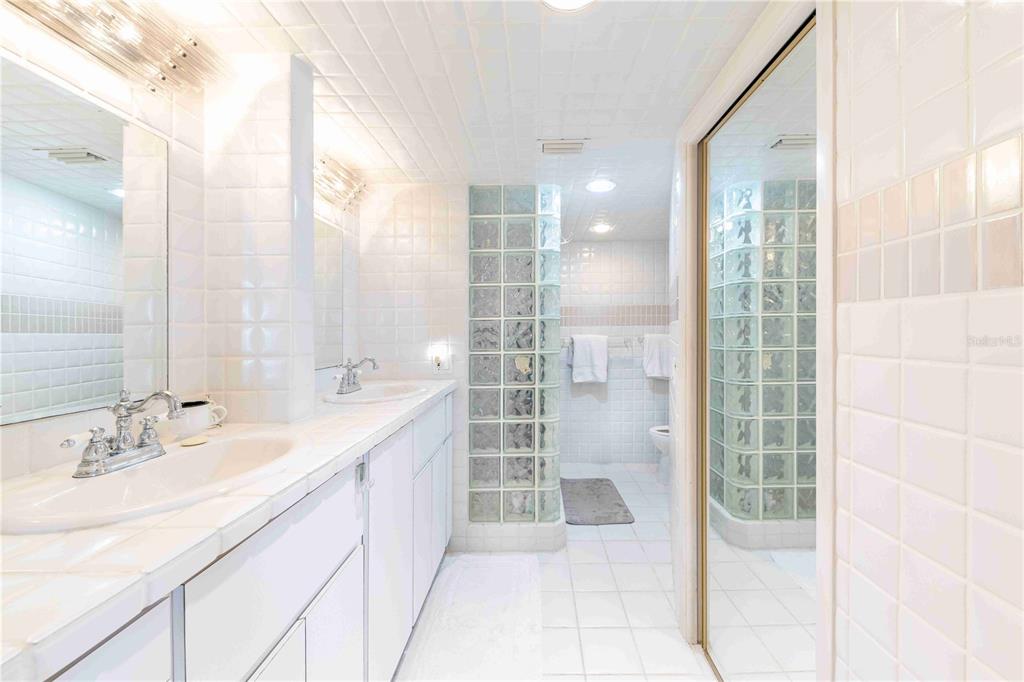 11000 Placida Road, Unit 101 Placida, FL 33946 - Photo 14 of 22 a bathroom with a double vanity sink and mirror