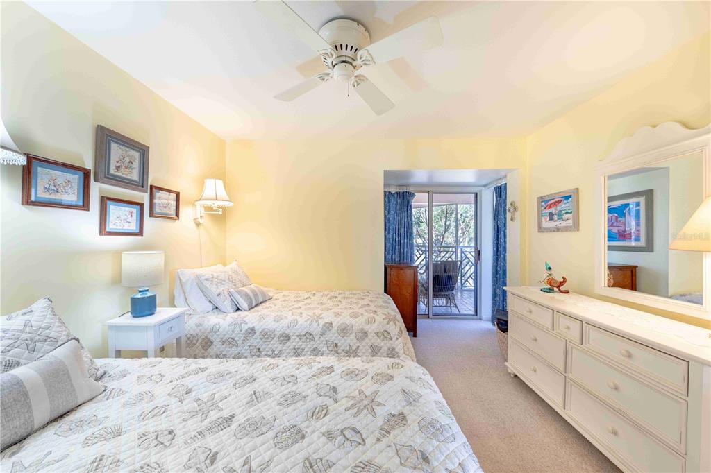 11000 Placida Road, Unit 101 Placida, FL 33946 - Photo 15 of 22 a bedroom with a large bed and a chandelier