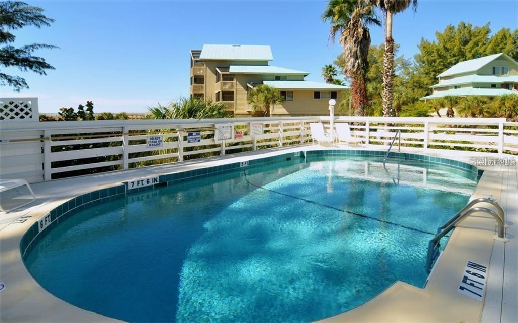 11000 Placida Road, Unit 101 Placida, FL 33946 - Photo 20 of 22 a view of a swimming pool with a yard