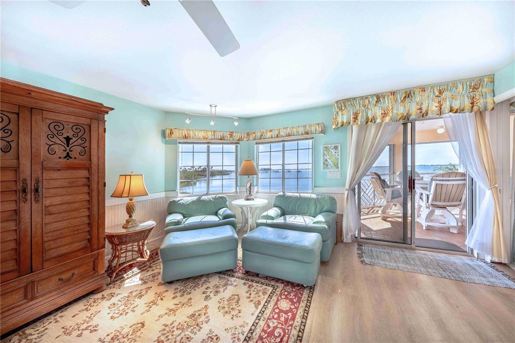 11000 Placida Road, Unit 101 Placida, FL 33946 - Photo 7 of 22 a living room with furniture and a floor to ceiling window