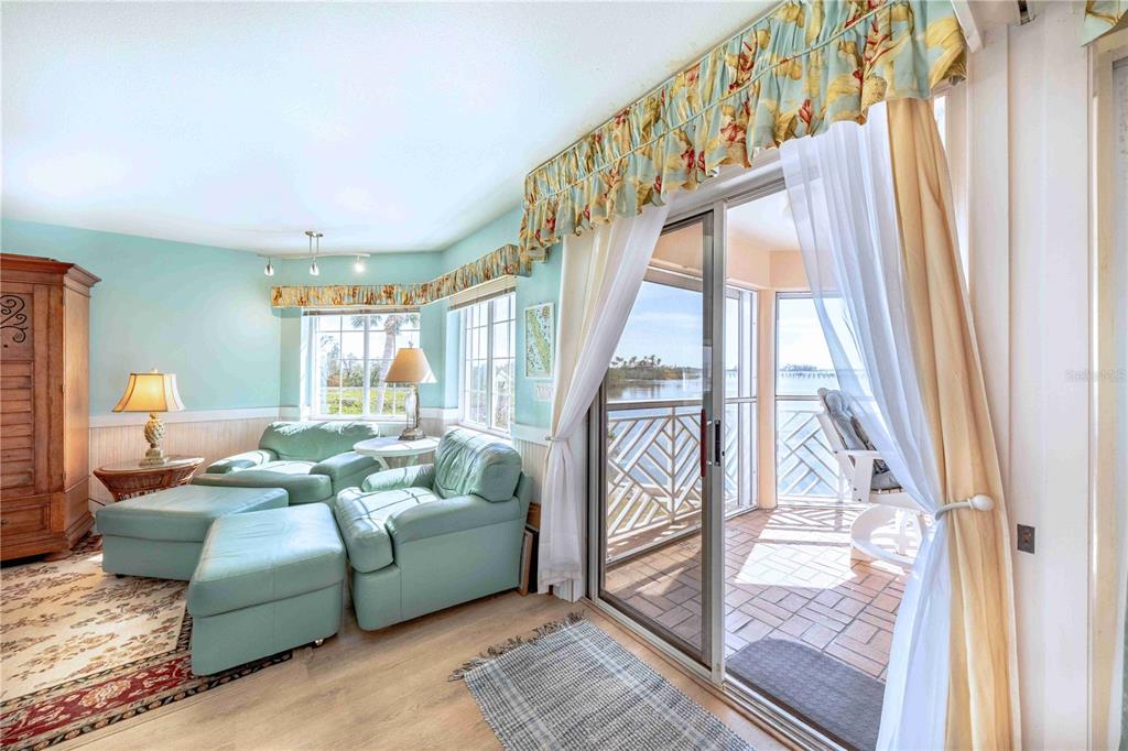 11000 Placida Road, Unit 101 Placida, FL 33946 - Photo 8 of 22 a living room with furniture and a floor to ceiling window