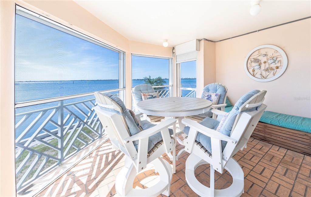 11000 Placida Road, Unit 101 Placida, FL 33946 - Photo 10 of 22 a view of a dining room with furniture and a large window