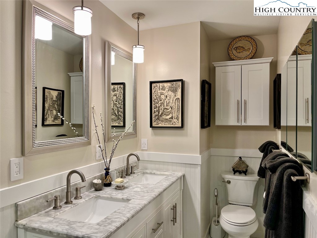 366 Russelton Road Boone, NC 28607 - Photo 11 of 29 a bathroom with a granite countertop toilet sink and mirror