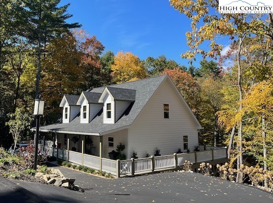 366 Russelton Road Boone, NC 28607 - Photo 2 of 29 a view of a white house with large windows and a tree