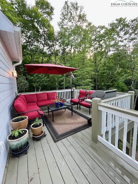 366 Russelton Road Boone, NC 28607 - Photo 23 of 29 a view of deck with table and chairs potted plants with wooden floor