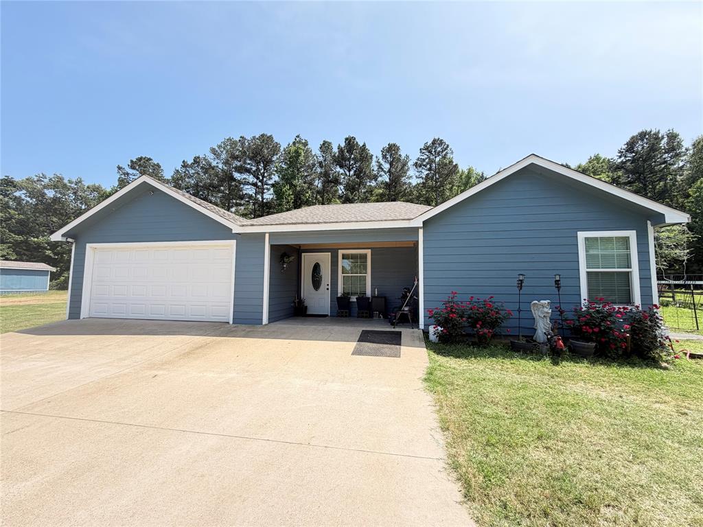 8261 County Road 381 Tyler, TX 75708 - Photo 3 of 40 a front view of house with yard outdoor seating and barbeque oven
