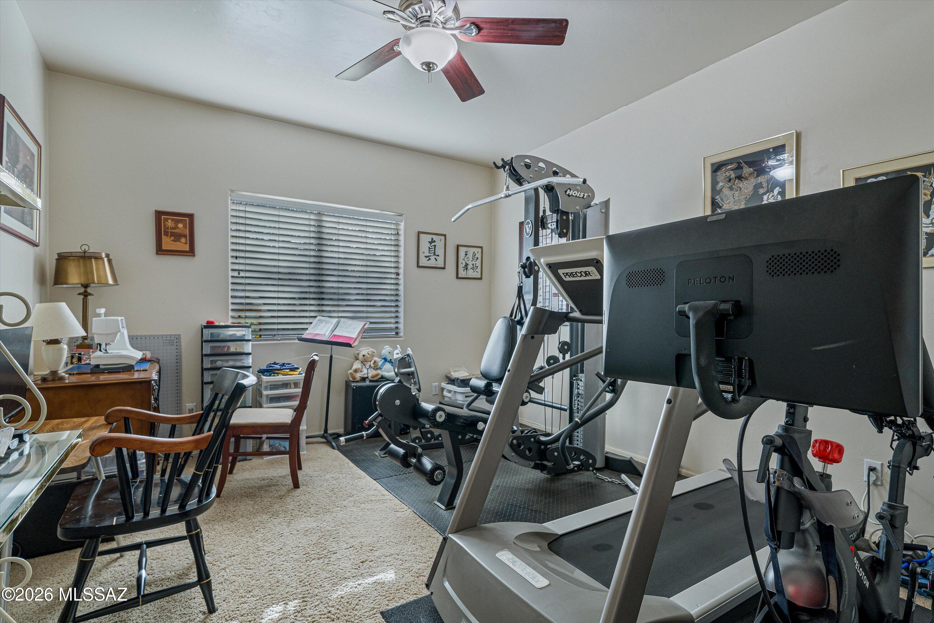 4677 East Rail N Road Tucson, AZ 85739 - Photo 17 of 48 A bedroom currently used as an exercise and sewing room