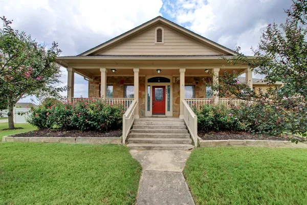 a front view of a house with garden