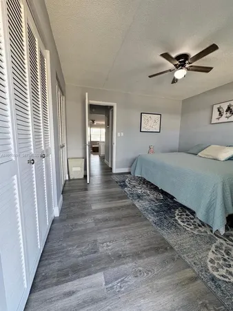 a spacious bedroom with a large bed and a chandelier