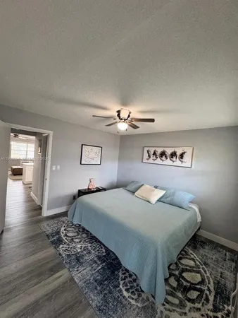 a bedroom with a bed and dresser with lamp