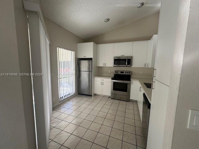 9336 Ketay Circle Boca Raton, FL 33428 - Photo 12 of 48 a kitchen with a stove a refrigerator and a sink