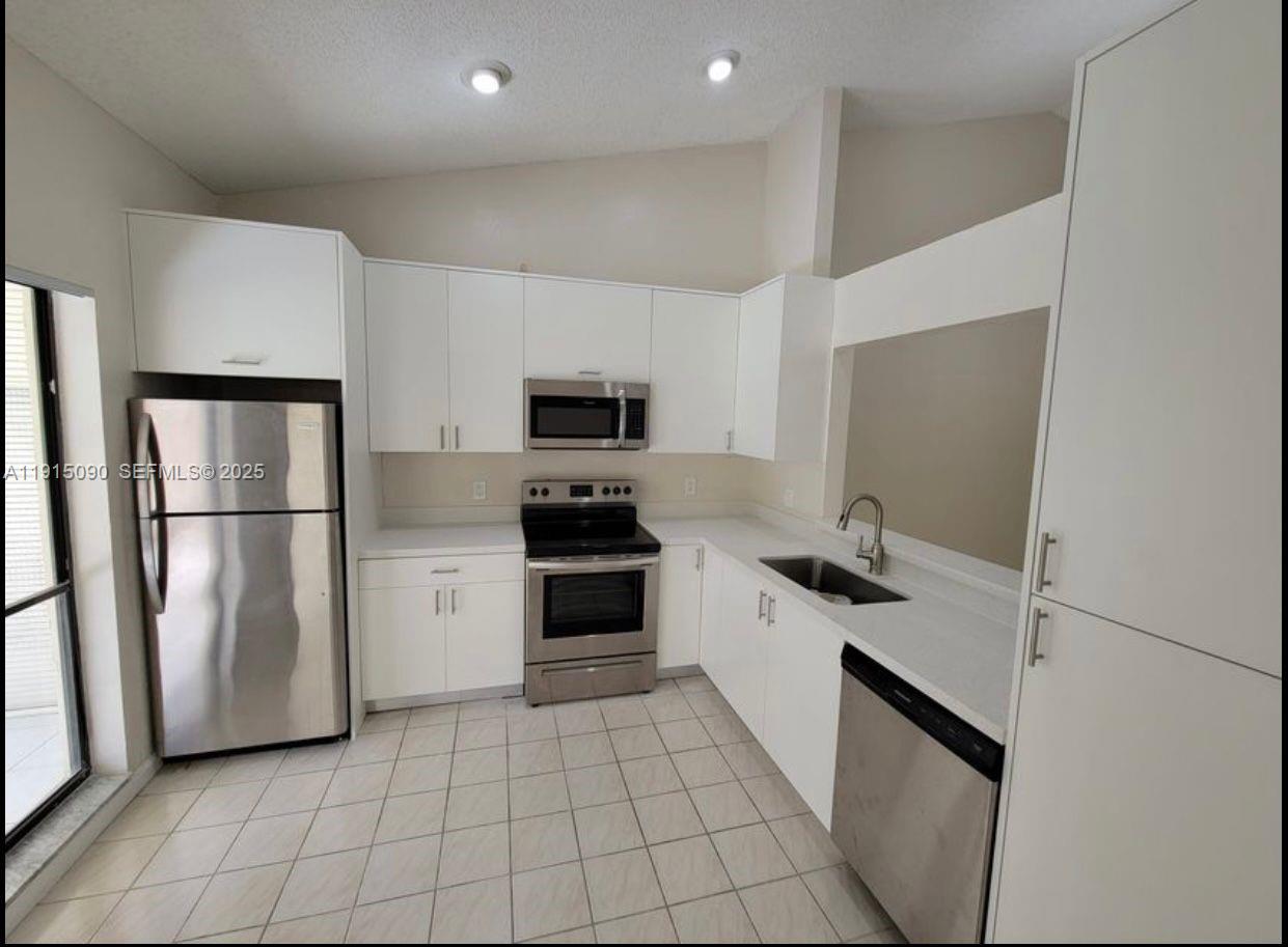 9336 Ketay Circle Boca Raton, FL 33428 - Photo 13 of 48 a kitchen with a sink appliances and cabinets