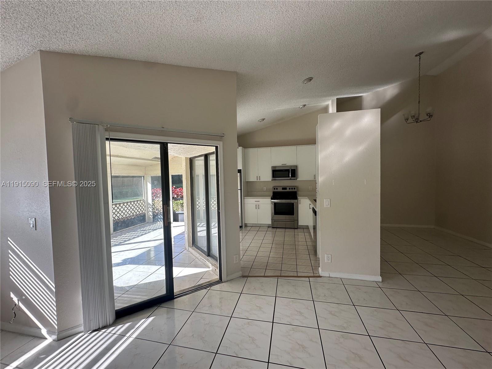 9336 Ketay Circle Boca Raton, FL 33428 - Photo 24 of 48 a kitchen with granite countertop a refrigerator and a counter top space