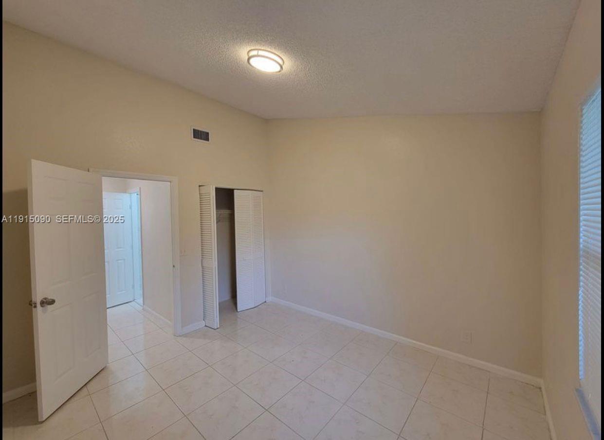 9336 Ketay Circle Boca Raton, FL 33428 - Photo 28 of 48 an empty room with closet area