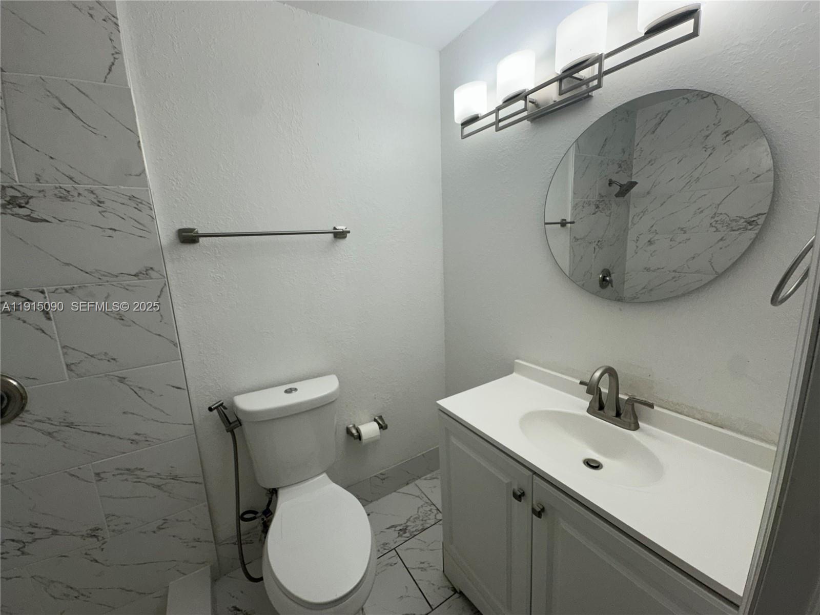9336 Ketay Circle Boca Raton, FL 33428 - Photo 38 of 48 a bathroom with a toilet sink and mirror