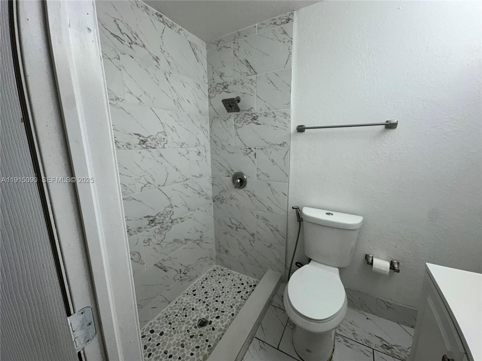 9336 Ketay Circle Boca Raton, FL 33428 - Photo 39 of 48 a white toilet sitting next to a shower