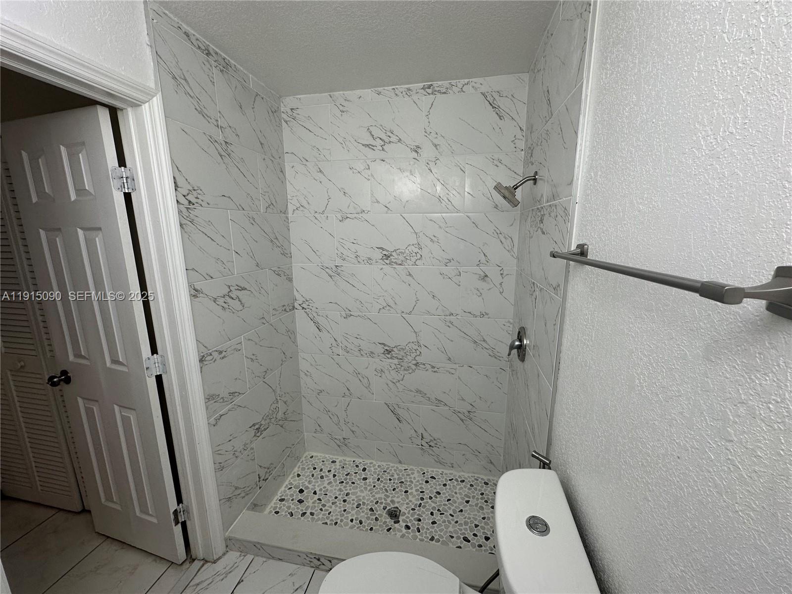 9336 Ketay Circle Boca Raton, FL 33428 - Photo 40 of 48 a bathroom with a shower and a toilet