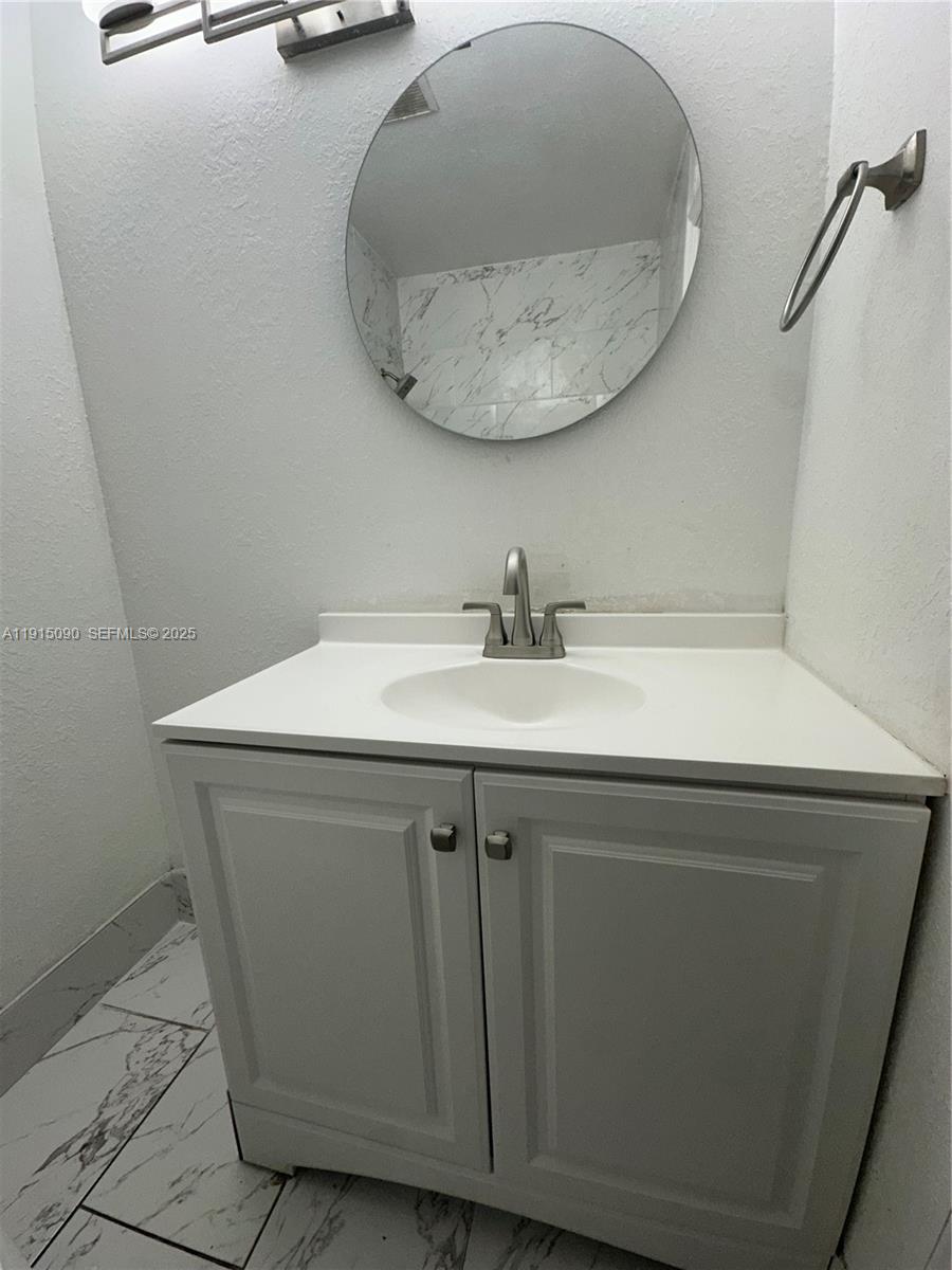 9336 Ketay Circle Boca Raton, FL 33428 - Photo 41 of 48 a bathroom with a sink and a mirror