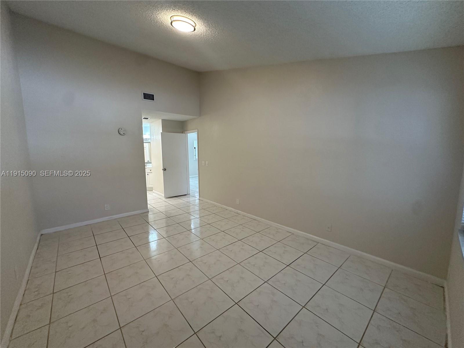 9336 Ketay Circle Boca Raton, FL 33428 - Photo 43 of 48 an empty room with white wall and tiles