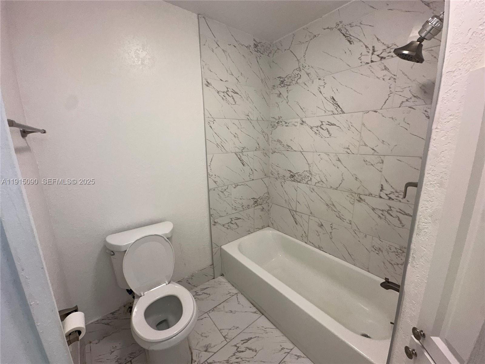9336 Ketay Circle Boca Raton, FL 33428 - Photo 47 of 48 a white toilet sitting next to a bath tub and a shower