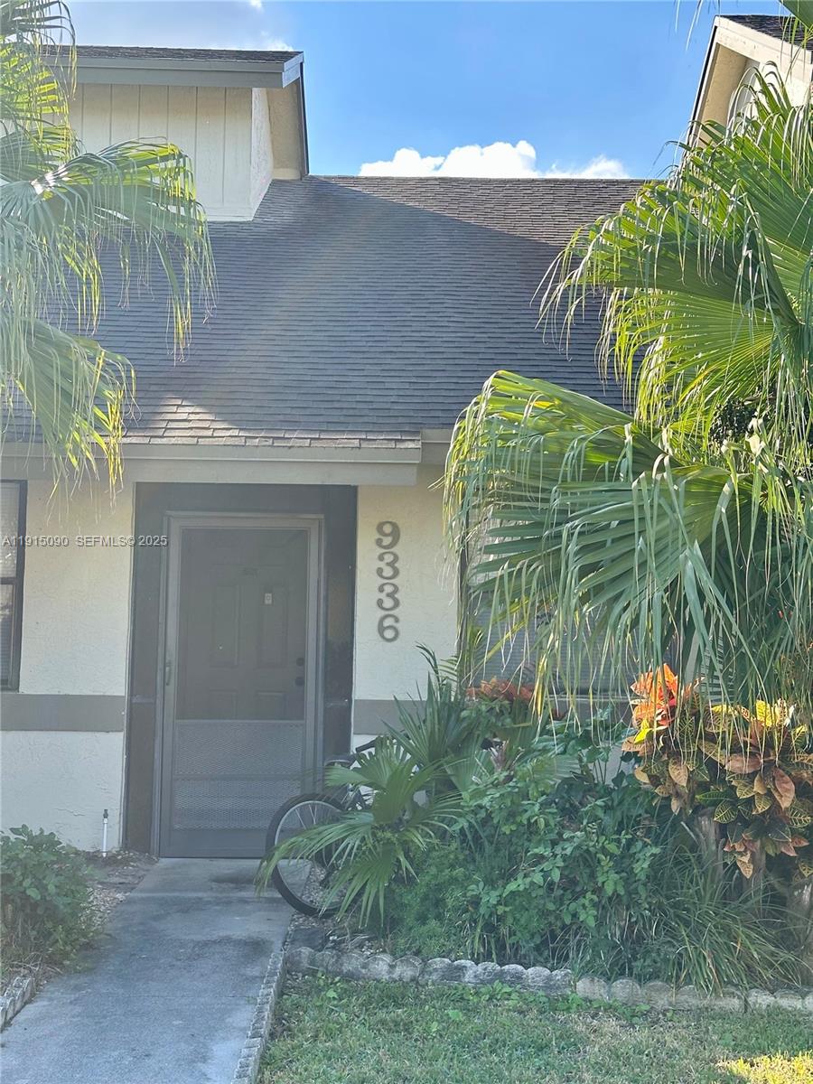 9336 Ketay Circle Boca Raton, FL 33428 - Photo 6 of 48 a front view of a house with a yard