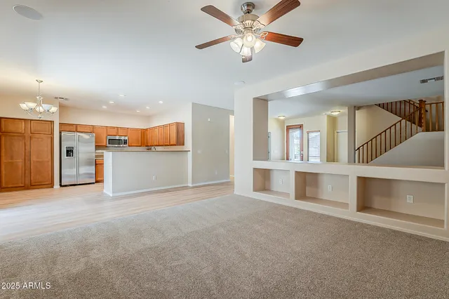a view of an empty room with a kitchen