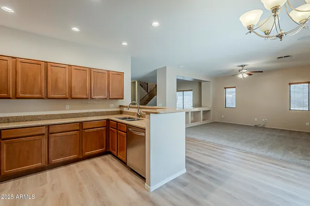 a kitchen with cabinets a sink and appliances