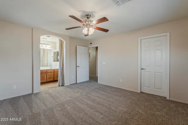 a view of an empty room with a fan