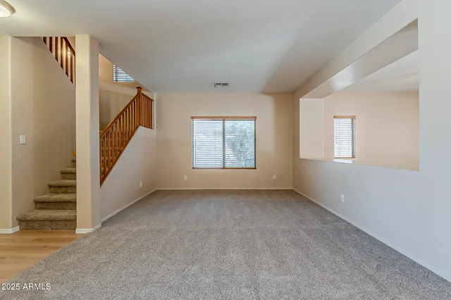 a view of an empty room with stairs