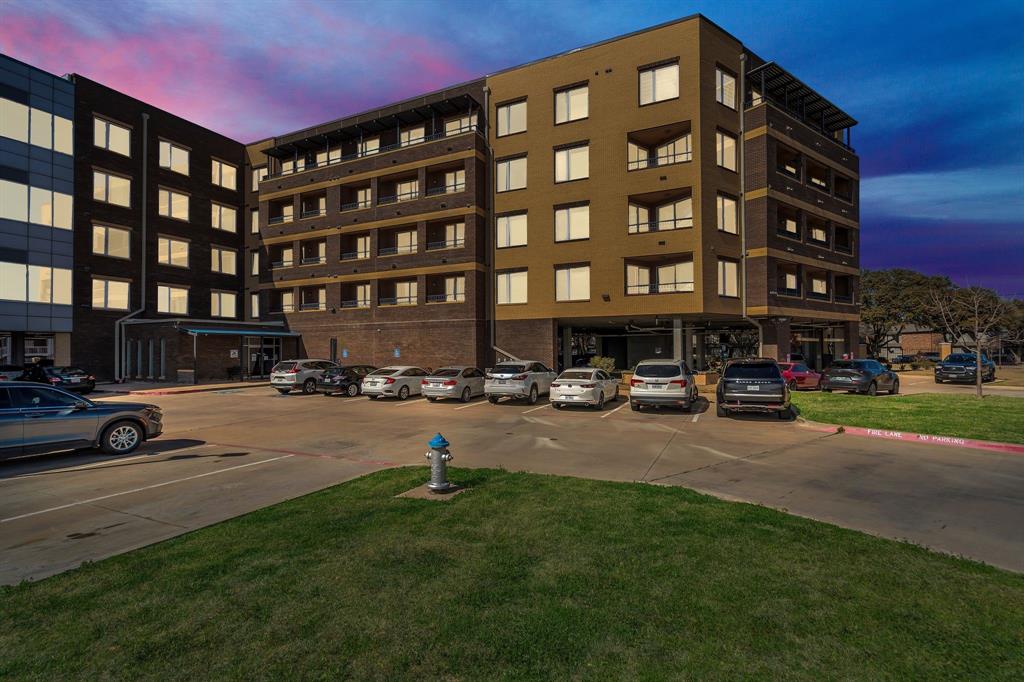 1220 West Trinity Mills Road, Unit 3013 Carrollton, TX 75006 - Photo 1 of 1 Property at dusk with uncovered parking
