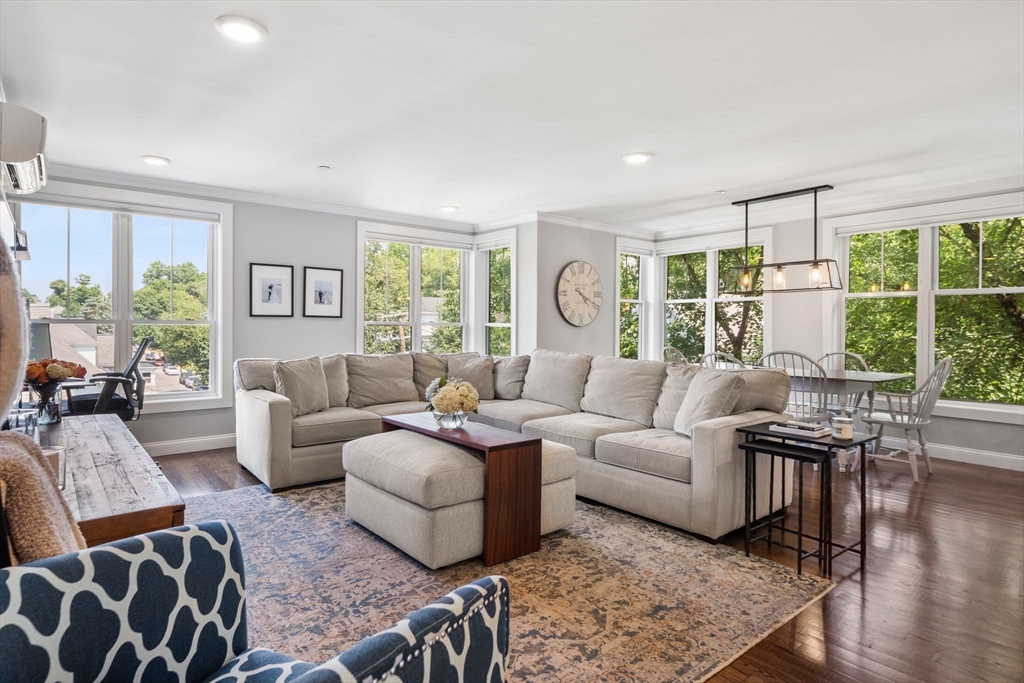 1789 Centre Street, Unit 401 Boston, MA 02132 - Photo 1 of 30 a living room with furniture and a large window