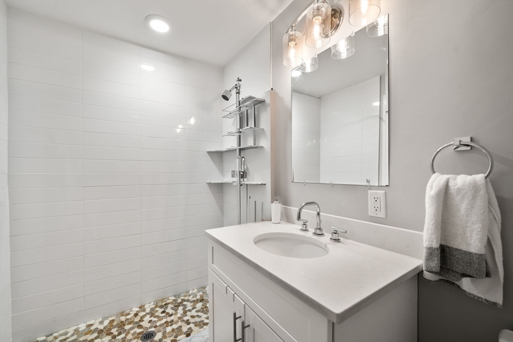 1789 Centre Street, Unit 401 Boston, MA 02132 - Photo 15 of 30 a bathroom with a sink and a mirror