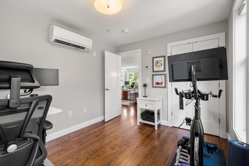 1789 Centre Street, Unit 401 Boston, MA 02132 - Photo 18 of 30 a view of a livingroom with furniture and a flat screen tv
