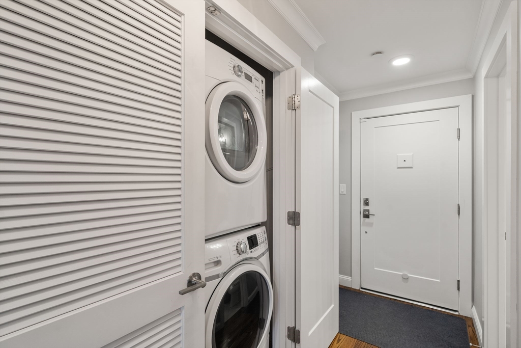 1789 Centre Street, Unit 401 Boston, MA 02132 - Photo 20 of 30 a view of a hallway with washer and dryer