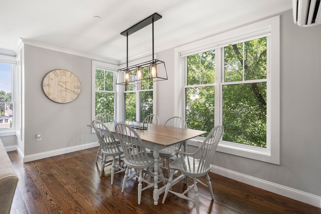 1789 Centre Street, Unit 401 Boston, MA 02132 - Photo 8 of 30 a view of a dining room with furniture window and wooden floor